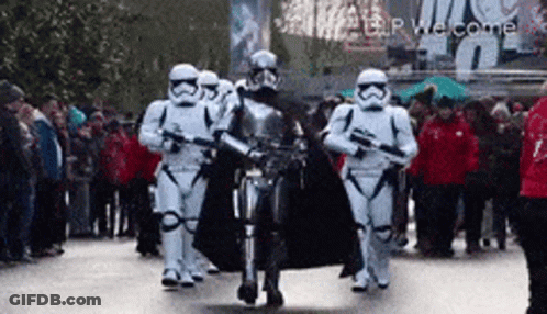 Stormtroopers Marching Down Street In Front Of Crowd GIF