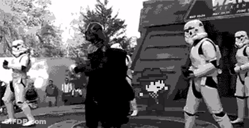 Stormtroopers Standing Around Man In Black And White Photo GIF