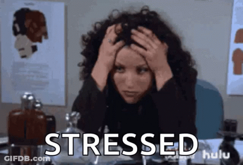 Stressed Woman At Desk With Hands On Head GIF