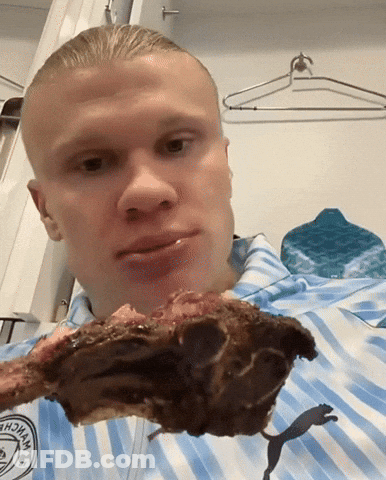 Striped Blue Shirt Man Holding Meat In Mouth GIF