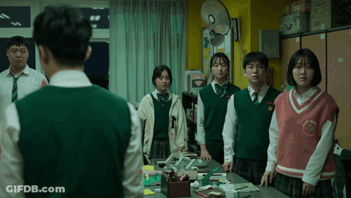 Students Standing Around Table With Vest Saying N GIF