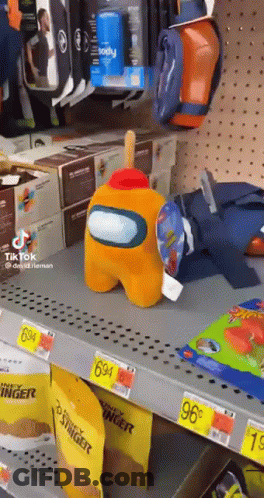 Stuffed Among Us Character Sitting On Shelf GIF