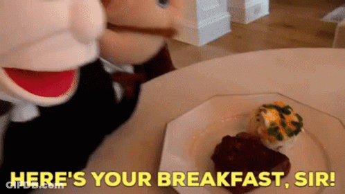 Stuffed Animal At Table With Breakfast Saying Here's Your Breakfast Sir GIF