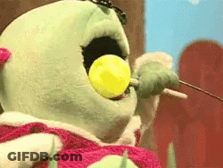 Stuffed Animal Eating Yellow Lollipop GIF