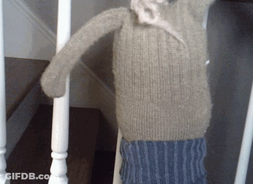 Stuffed Animal Hanging On Staircase Railing GIF