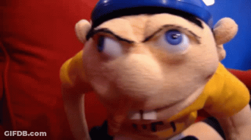 Stuffed Animal In Yellow Shirt And Blue Hat GIF