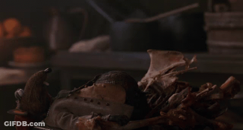 Stuffed Animal Lying On Bones GIF