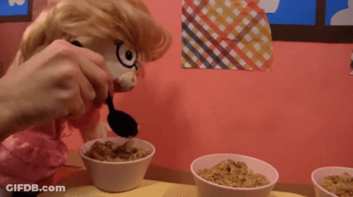 Stuffed Animal Pouring Cereal With Black Spoon GIF