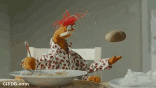Stuffed Animal Sitting At Table With Cereal And Flying Potato GIF