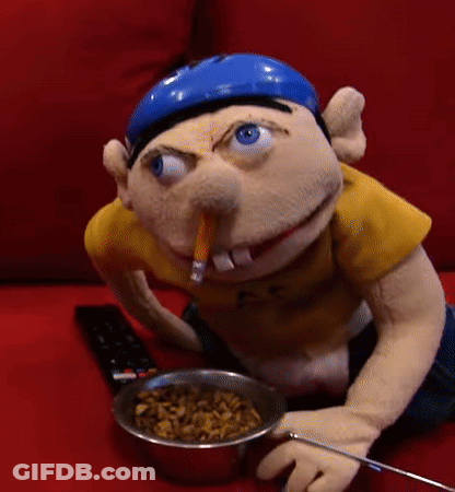 Stuffed Animal Sitting On Red Couch With Cereal GIF