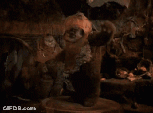 Stuffed Animal Standing On Wooden Stump GIF