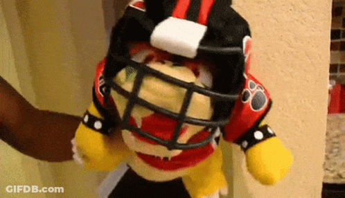 Stuffed Animal Wearing Football Helmet And Jersey GIF