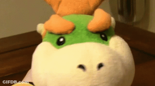Stuffed Animal With Green And Orange Face GIF