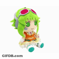 Stuffed Animal With Green Hair And Glasses Laying Upside Down GIF