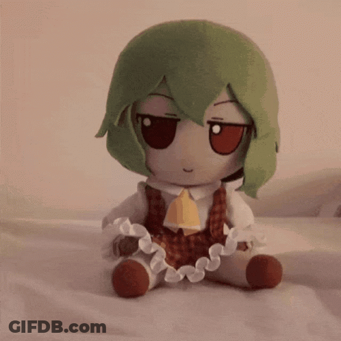 Stuffed Animal With Green Hair Sitting GIF