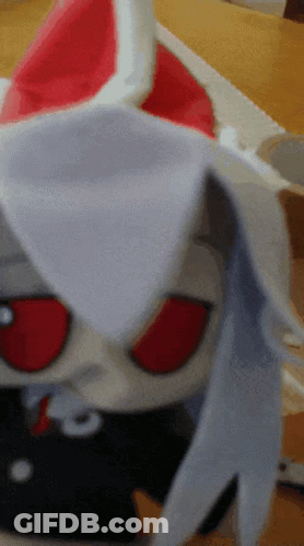 Stuffed Animal With Red Eyes On Table GIF