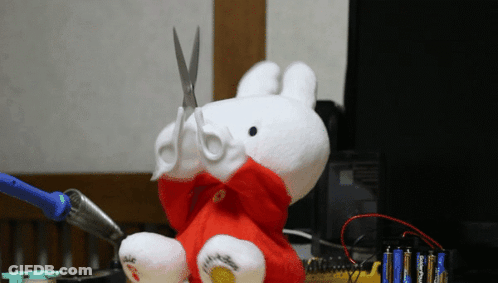 Stuffed Animal With Scissors In Mouth GIF