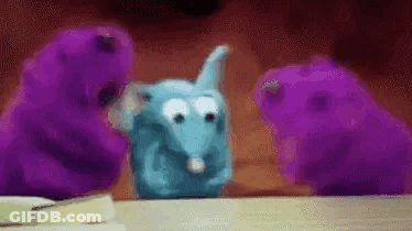 Stuffed Animals In Front Of Christmas Wreath GIF