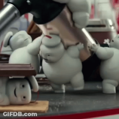 Stuffed Animals Including Marshmallow Man Standing Around Table GIF
