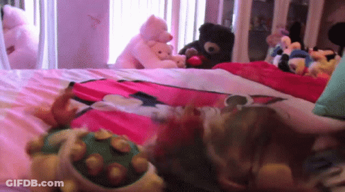 Stuffed Animals Laying On Bed Including Turtle GIF