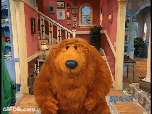 Stuffed Bear Standing In Front Of Sprout Sign GIF