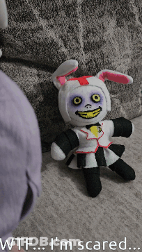 Stuffed Bunny Sitting On Couch Wtf I'm Scared GIF