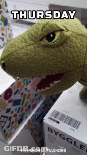 Stuffed Dinosaur Sitting On Box Saying Byggle GIF