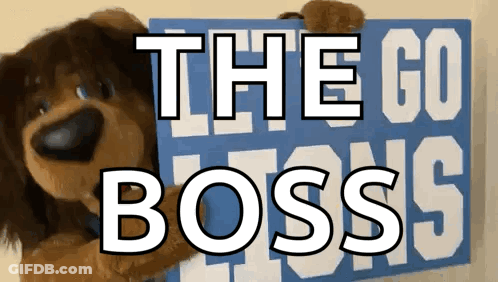 Stuffed Dog Holding Sign Saying The Go Boss GIF