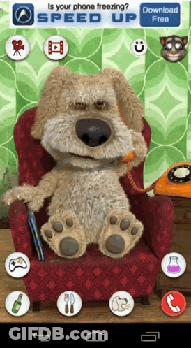 Stuffed Dog Sitting In Chair With Phone In Mouth GIF