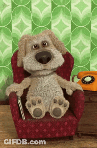 Stuffed Dog Sitting In Red Chair GIF