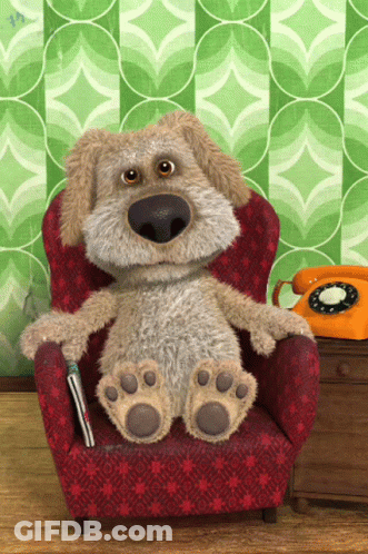 Stuffed Dog Sitting In Red Chair Next To Orange Phone GIF