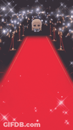 Stuffed Doll Standing On Red Carpet In Front Of Crowd GIF