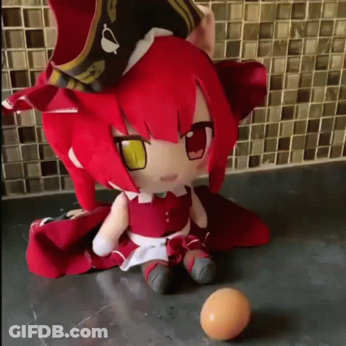 Stuffed Doll With Red Hair And Yellow Eyes Next To Ball GIF