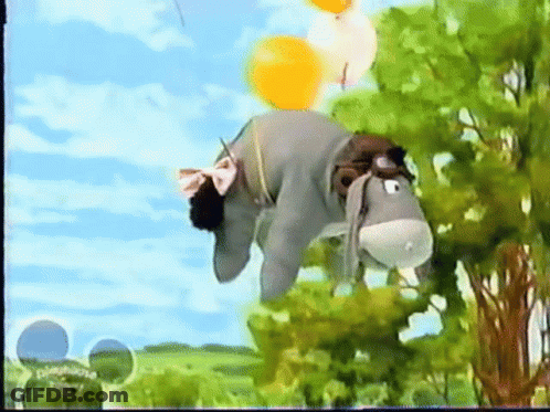 Stuffed Donkey Hanging From Tree With Balloons GIF