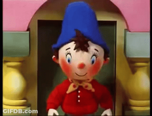 Stuffed Gnome Blue Hat Red Shirt Pink Building GIF