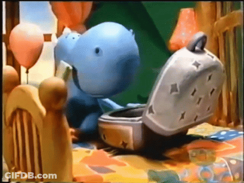 Stuffed Hippo Sitting On Bed Next To Toaster GIF