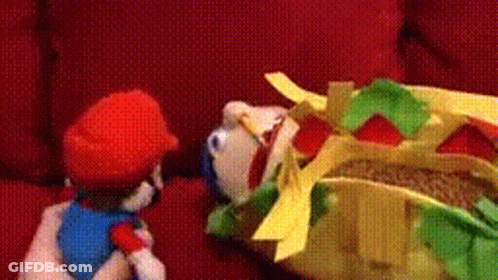 Stuffed Mario On Red Couch With Stuffed Hot Dog GIF