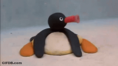 Stuffed Penguin Blowing Balloon GIF