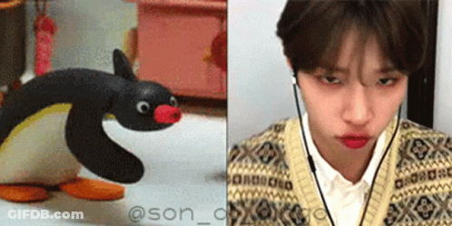 Stuffed Penguin Next To Man With Headphones GIF