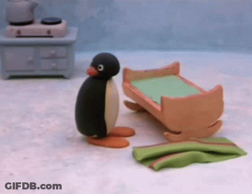 Stuffed Penguin Next To Rocking Cradle GIF