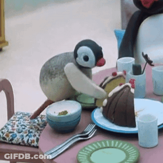 Stuffed Penguin Sitting With Cake GIF