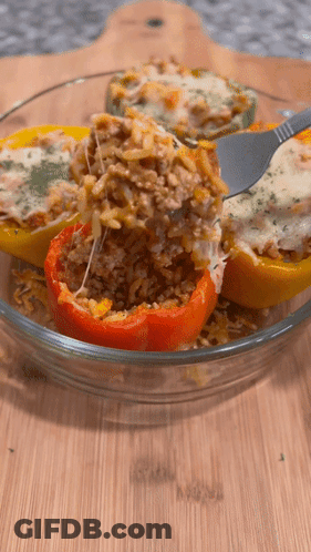 Stuffed Peppers In A Glass Bowl With A Fork GIF