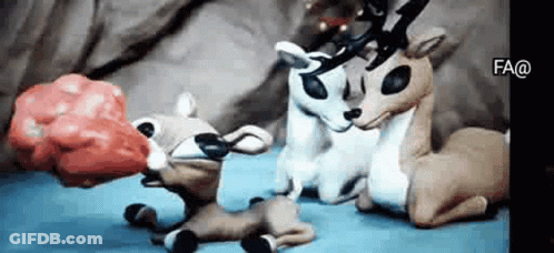 Stuffed Reindeer Sitting On Bed GIF