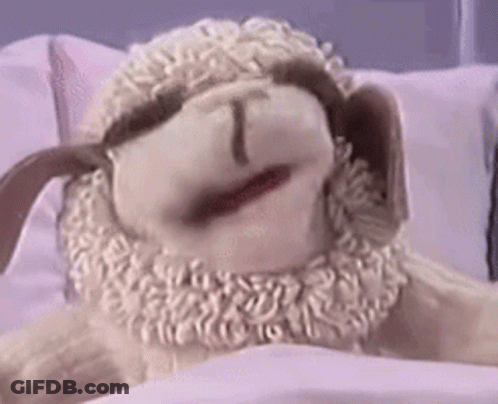 Stuffed Sheep Laying On Bed Mouth Open GIF