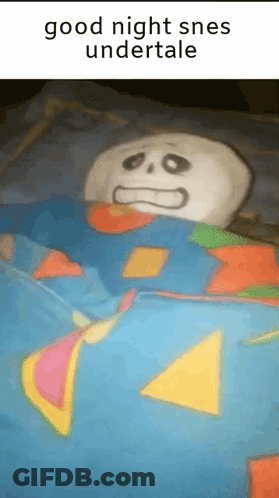 Stuffed Skeleton Laying In Bed With Blue Blanket GIF