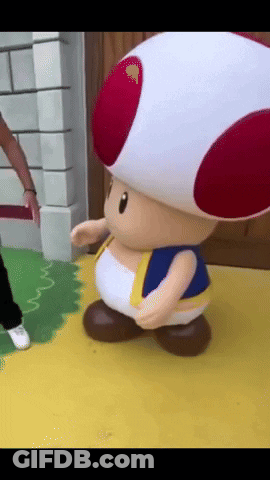 Stuffed Toad With Red And White Hat On Yellow Floor GIF