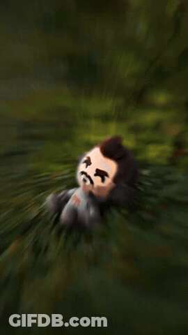 Stuffed Toy Man With Beard Sitting In Grass GIF