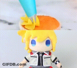 Stuffed Toy With Yellow Hair And Blue Eyes Decorated With Icing GIF