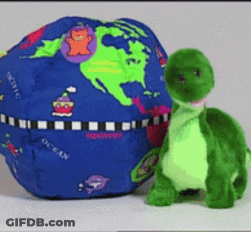 Stuffed Turtle Next To Blue Globe Saying Ocean GIF