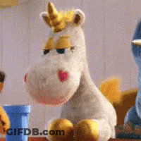 Stuffed Unicorn With Yellow Horn Sitting Beside Another Stuffed Animal GIF